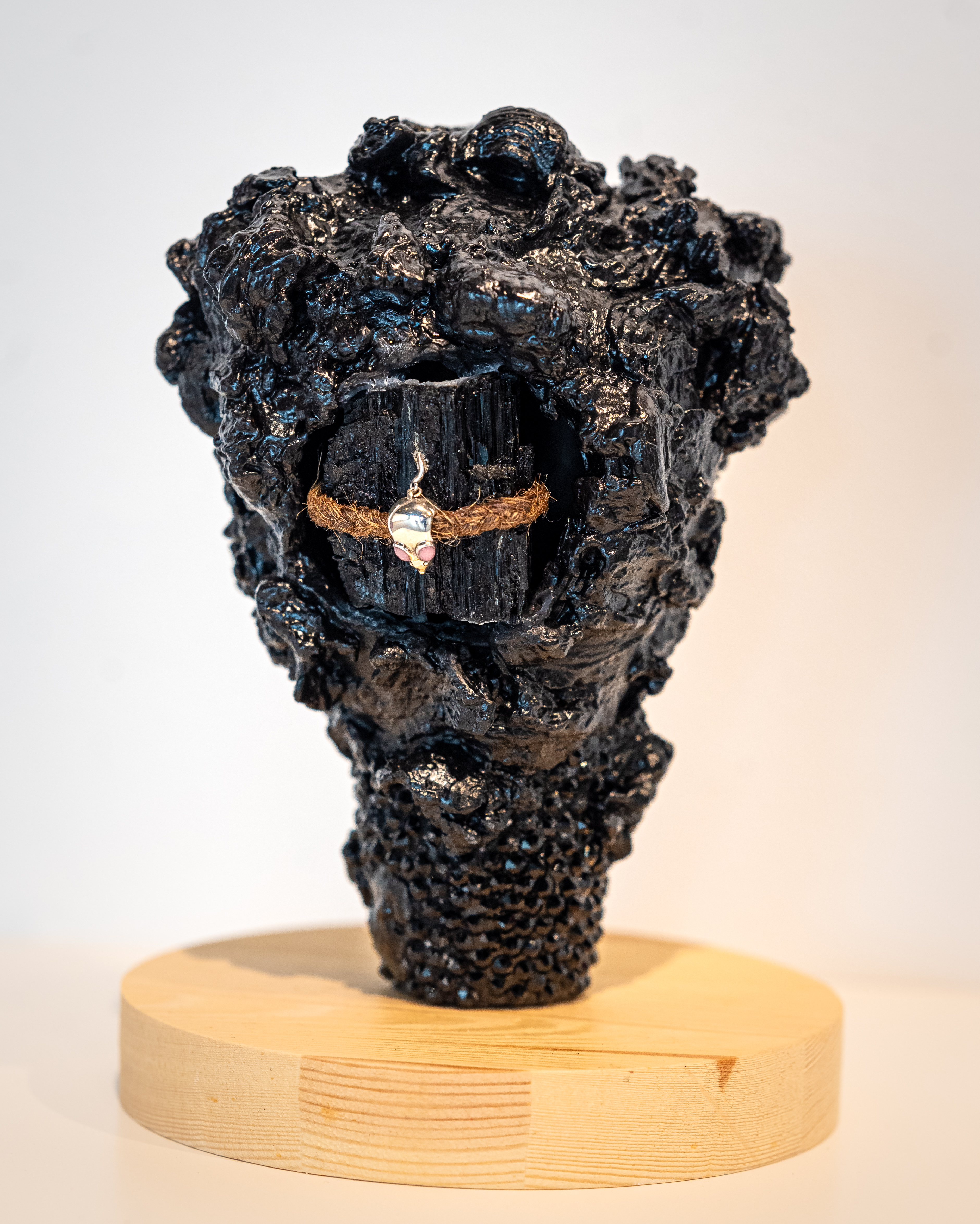LaShawnda Crowe Storm - Infinite Continuum installation image 1. Cast metal, twine, charm, wooden base,