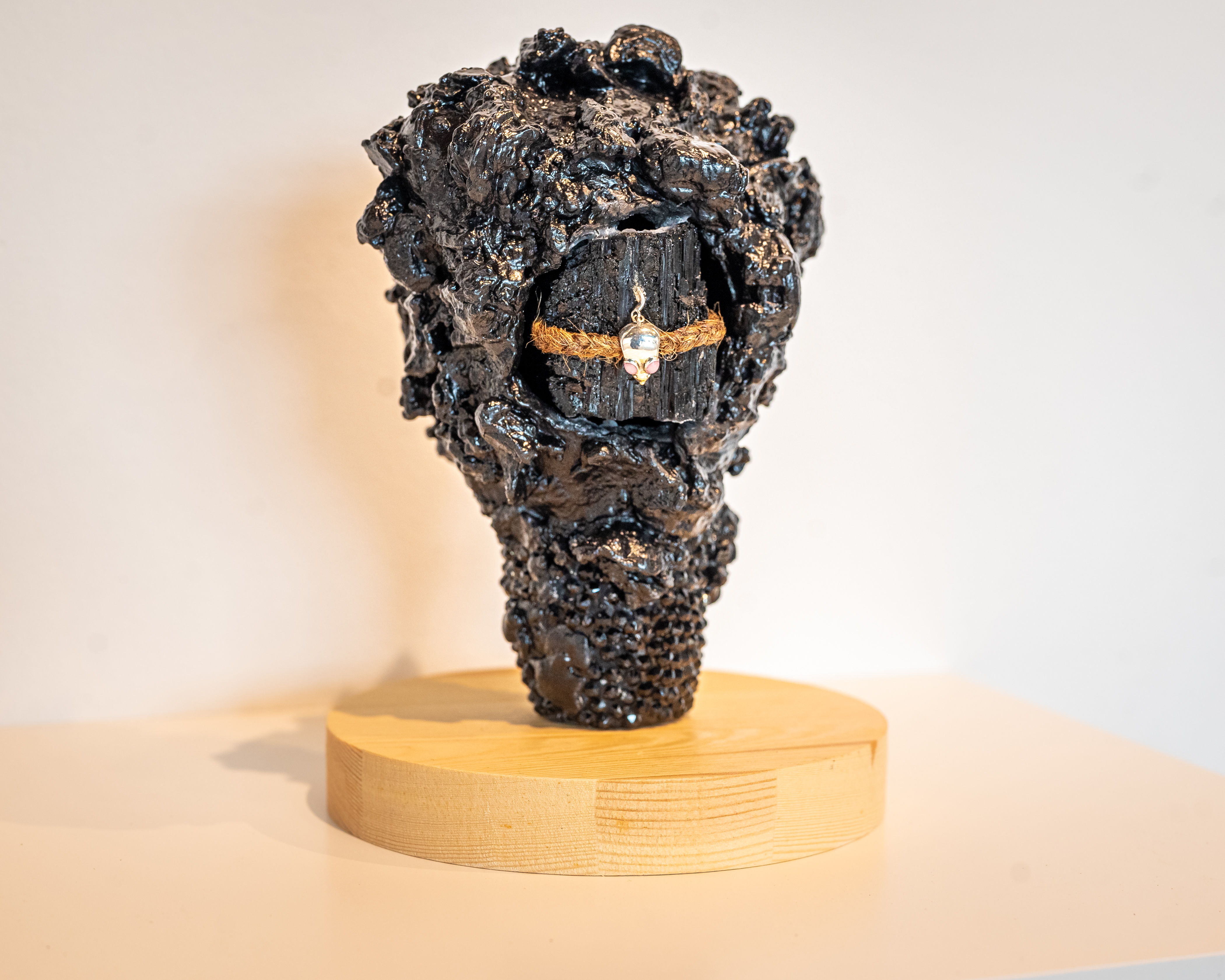 LaShawnda Crowe Storm - Infinite Continuum installation image 2. Cast metal, twine, charm, wooden base,
