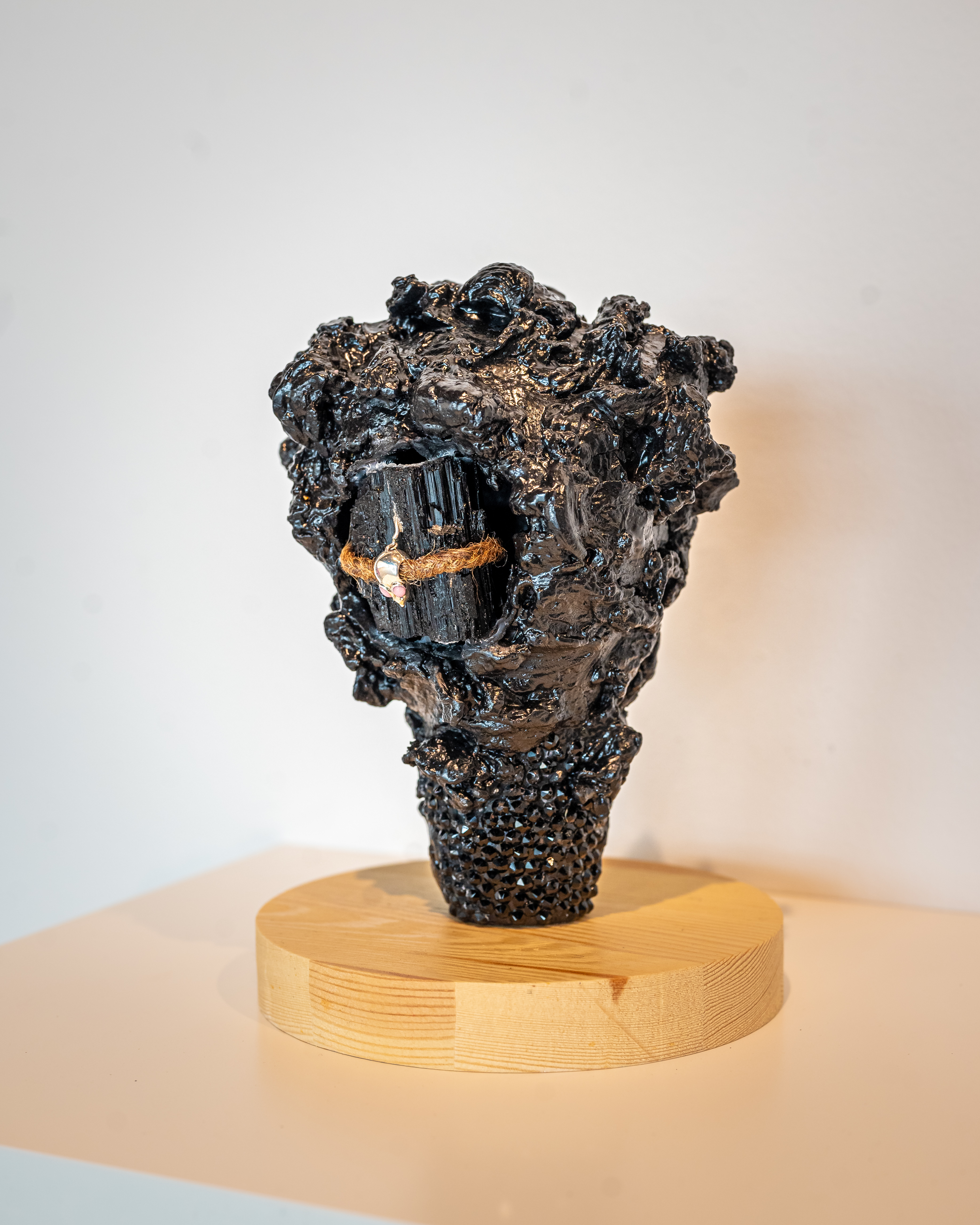 LaShawnda Crowe Storm - Infinite Continuum installation image 3. Cast metal, twine, charm, wooden base,
